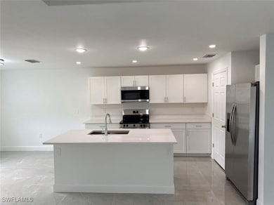 Kitchen with appliances with stainless steel finis