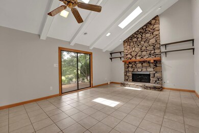Unfurnished living room with beamed ceiling, a sto