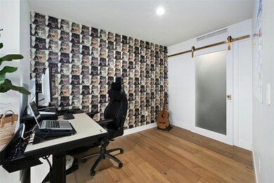Office area featuring visible vents, a barn door,