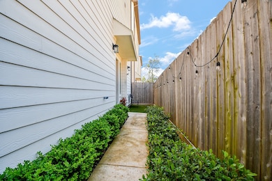 A landscaped side yard walkway with trimmed hedges
