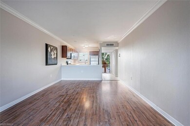 Unfurnished living room featuring crown molding an