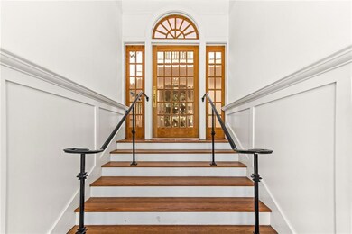 Grand entry staircase with original 1915 wooden an