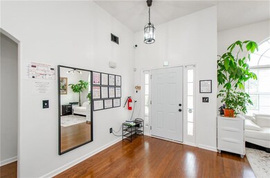 Entryway with dark wood-style floors and baseboards