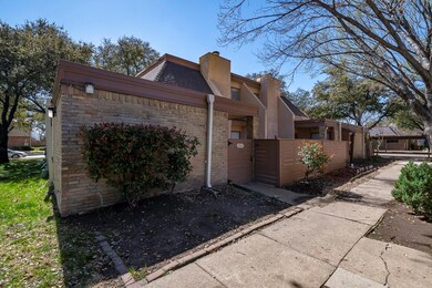 View of home's exterior featuring a gate, brick si