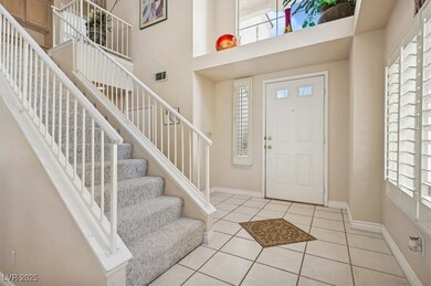 Tiled foyer with a wealth of natural light, stairs