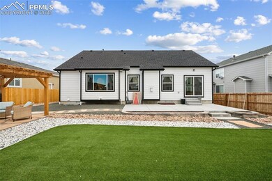 Rear view of property featuring a patio area, a shingled roof, a pergola, and entry steps