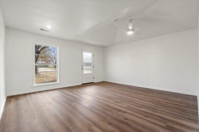 Spare room with dark hardwood / wood-style floorin