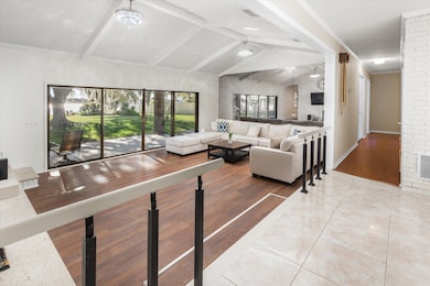 Living area with light wood finished floors and baseboards