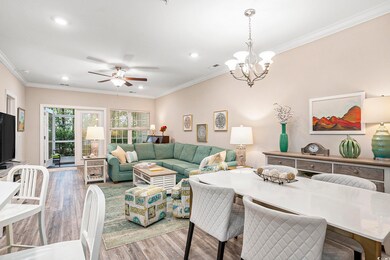 Living area with ornamental molding, wood finished floors, a ceiling fan, a chandelier, and recessed lighting
