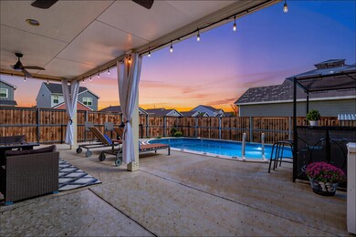 View of swimming pool with a patio area, ceiling fan, a fenced backyard, and outdoor dining space