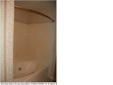 Master bathroom has his/her sinks, large mirror, n