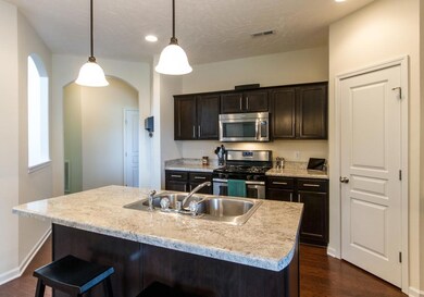 Large pantry and an island with bar seating.