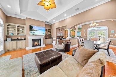 Living room featuring ceiling fan with notable cha