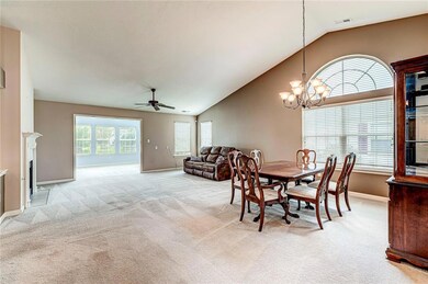 From the entry hall you see the huge great room and dining room with arched window.