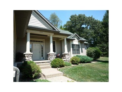Yard. Aggregate walkways lead to the front porch.