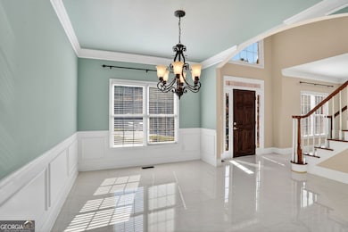 Formal Dining Room with beautiful fixtures & trim work.