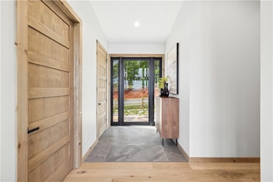 Foyer with recessed lighting and light wood-type flooring