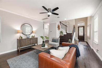Rich dark mahogany wood flooring flows through the main living, kitchen and stairwell