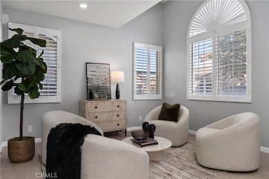LIVING ROOM WITH NEW FLOORING, NEW BASEBOARDS, NEW PAINT, CUSTOM SHUTTERS.
