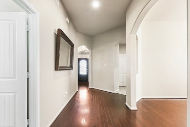 As you continue past the foyer, you'll pass the mud space leading to the two-car garage and a separate door to the laundry room. Further down, you'll find the formal dining room. Across from the dining room is the fourth room, a versatile space currently being used as a fully equipped media room.