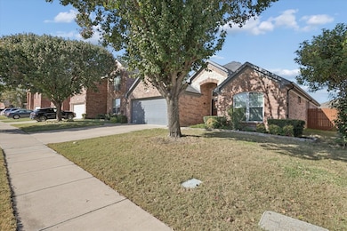 View of front of home with brick siding, concrete driveway, and a garage