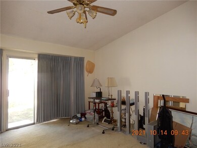 Primary bedroom has vaulted ceilings and ceiling f