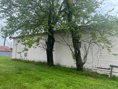 View of property exterior with a lawn and stucco siding