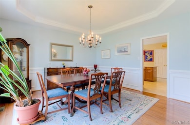 Formal Dining room. Can fit a very large dining room table and china cabinet! Picture frame molding, chair rail molding, & a tray ceiling with a chandelier.