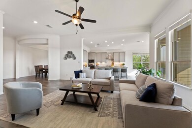 Living room featuring ornamental molding, recessed lighting, light wood-type flooring, ceiling fan, and baseboards