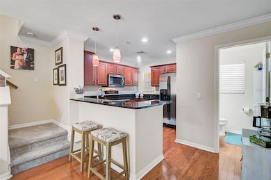 The kitchen includes a breakfast bar with granite countertops and stainless steel appliances, perfect for casual dining and entertaining.