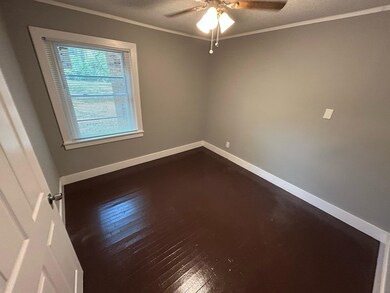 Unfurnished room with dark hardwood / wood-style f