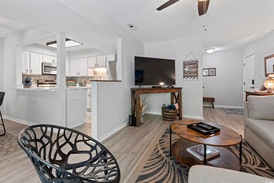 Living room with light wood finished floors, a cei