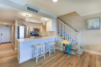 Kitchen with white cabinets, kitchen peninsula, li