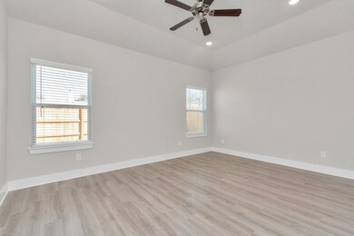 Spacious Primary Bedroom with ceiling fan.