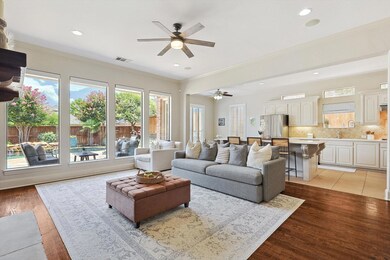 Tiled living room with ceiling fan and ornamental 