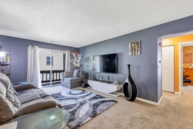 Large family room with sliding door leading to balcony