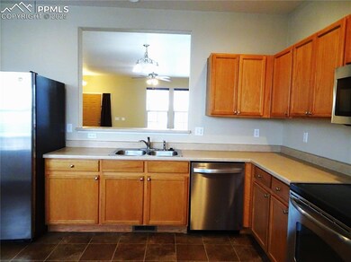 Kitchen with ceiling fan, hanging light fixtures, 