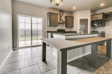 Kitchen with wall chimney exhaust hood, a kitchen 