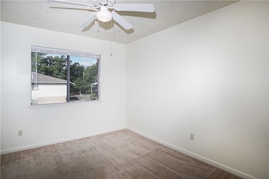 Carpeted spare room with baseboards and a ceiling