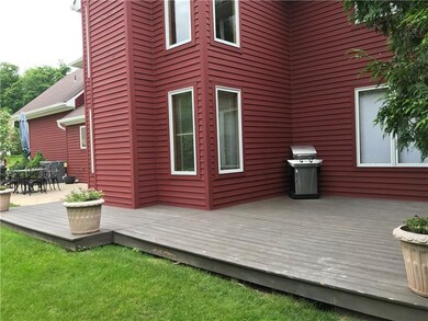 back of house showing concrete patio and wood deck