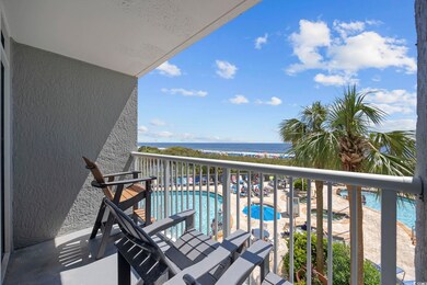 Balcony featuring a community pool and a water vie