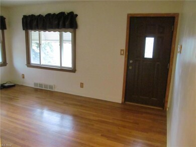 The living boasts gorgeous hardwood floors, a larg