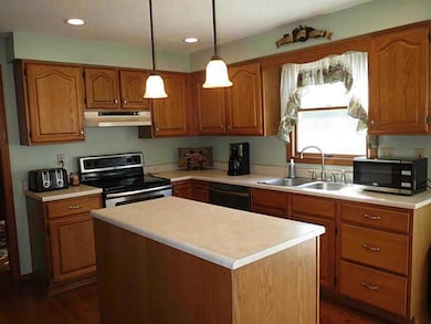 Kitchen. Stainless steel electric range w/convection oven capability, dishwasher, refrigerator included in sale. New stainless steel range hood and disposal installed in 2013