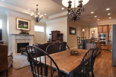 Dining area is open to kitchen, sunroom and living area.  Custom lighting.