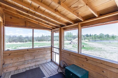 Sunroom featuring wooden ceiling, hardwood / wood-style floors, a water view, plenty of natural light, and wood walls