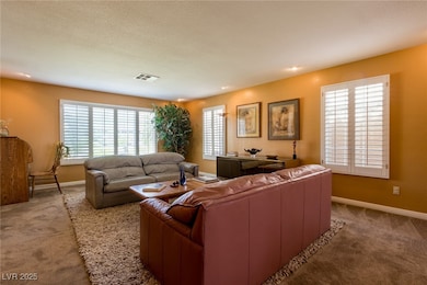 Carpeted living area with plenty of natural light