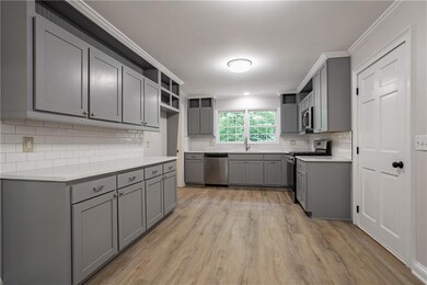 Kitchen with light wood finished floors, open shel