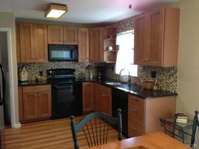 The kitchen features new backsplash, floor, countertops, and a great view to the back yard.