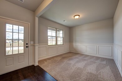 Flex room at entrance.  Subject home will have wood floors in this room and no wainscoting.  All photos are of a similar home, not of actual property listed