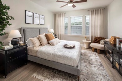 Bedroom with wood-style flooring and ceiling fans